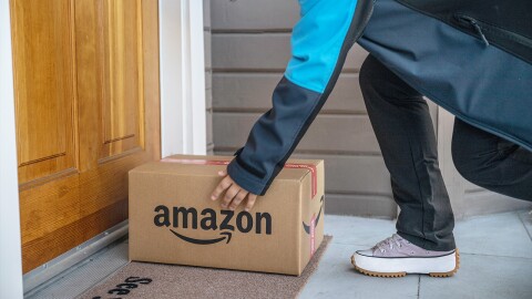 An Amazon driver delivers a package to a customer's doorstep.