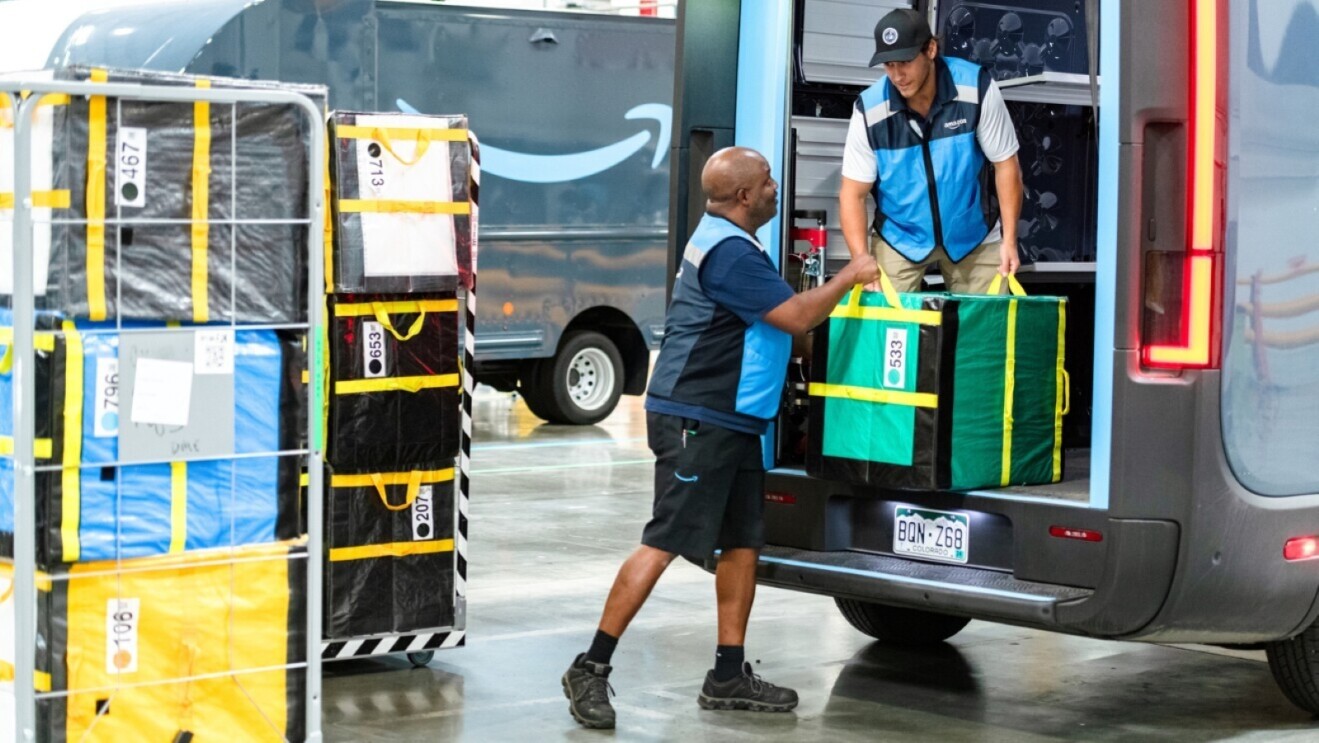 Amazon delivery workers loading packages into van