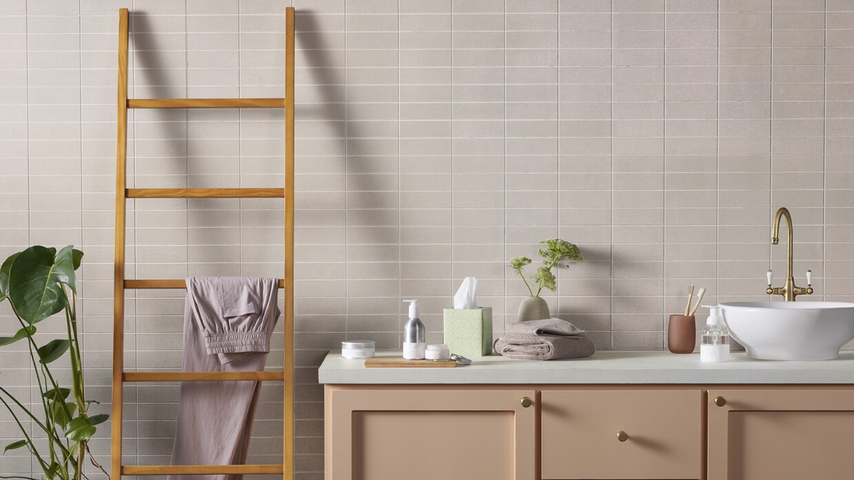 A picture of several new Amazon Aware products on a bathroom counter and leaning towel rack.