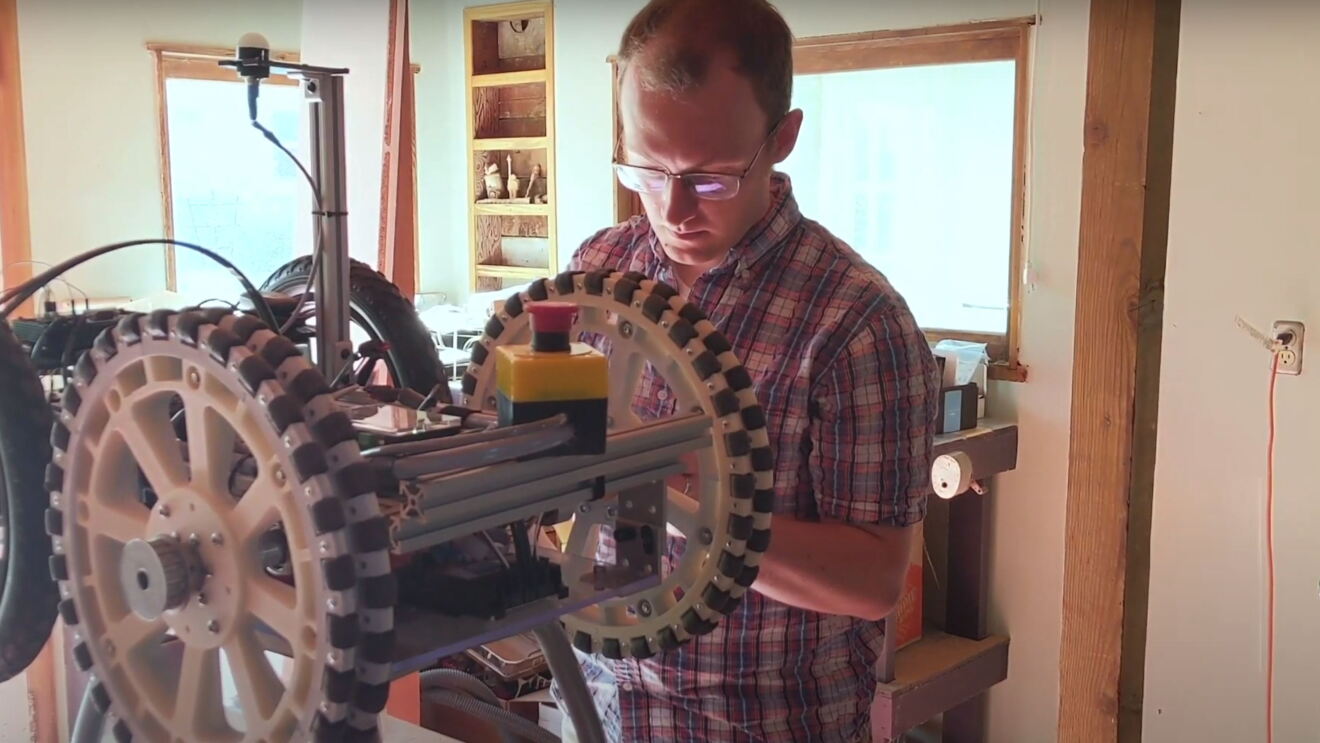An Amazon employee works on a robotic drivetrain at his home, during COVID-19 pandemic.