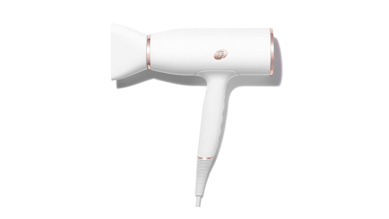 An image of a white hairdryer with gold details.