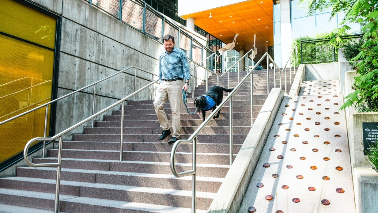 Chris and Sadie walk down the stairs outside of Amazon's hedquarters.