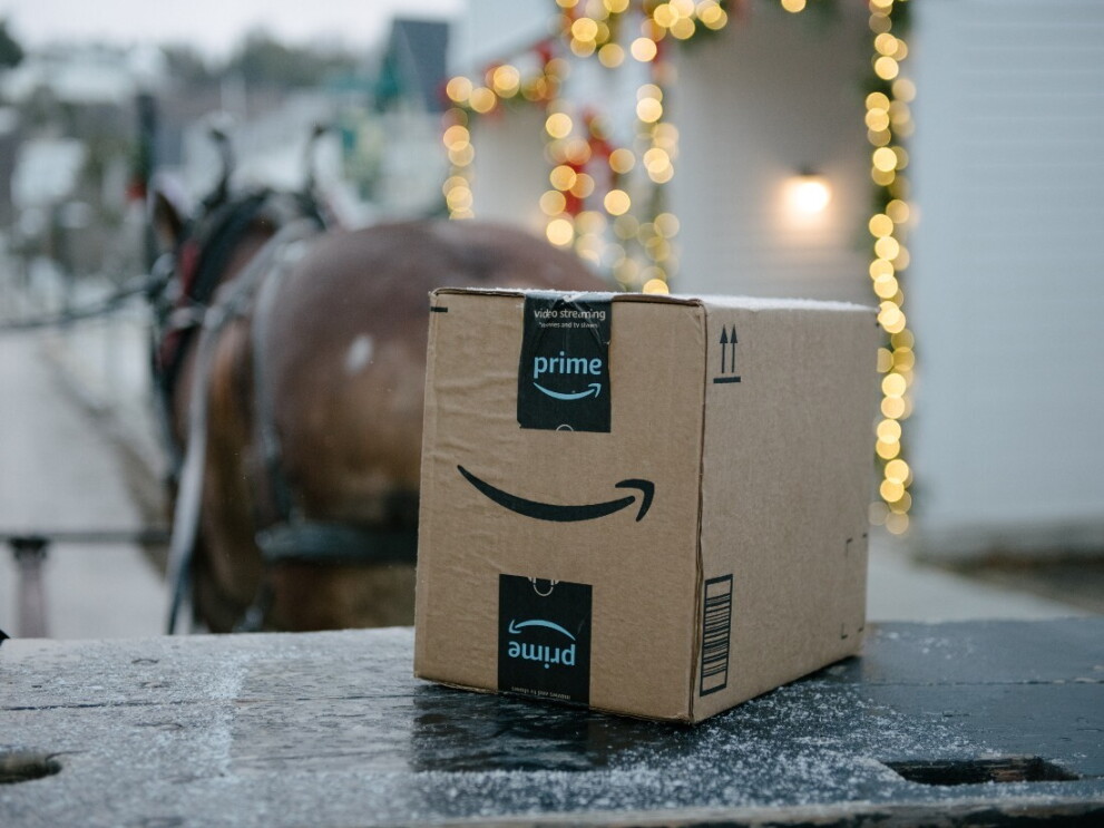 An Amazon box sits on a horse carriage.