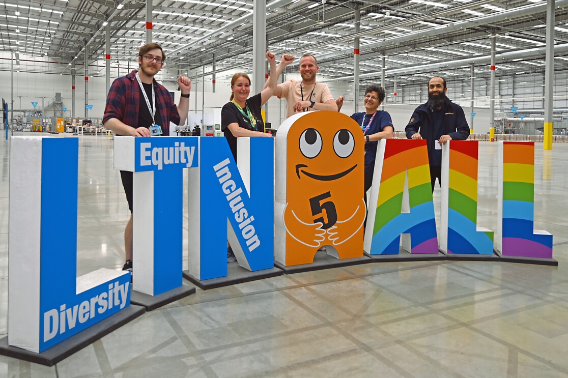 Staff members at LTN5 gathered around the entrance sign.