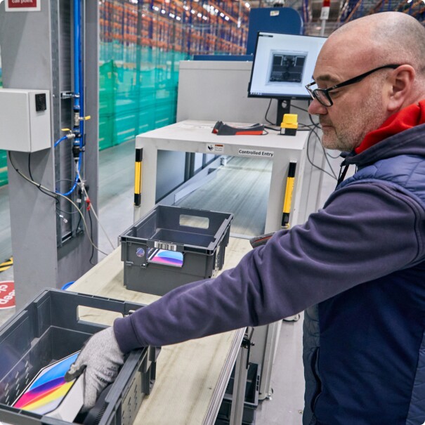 Worker operating controlled entry system in warehouse