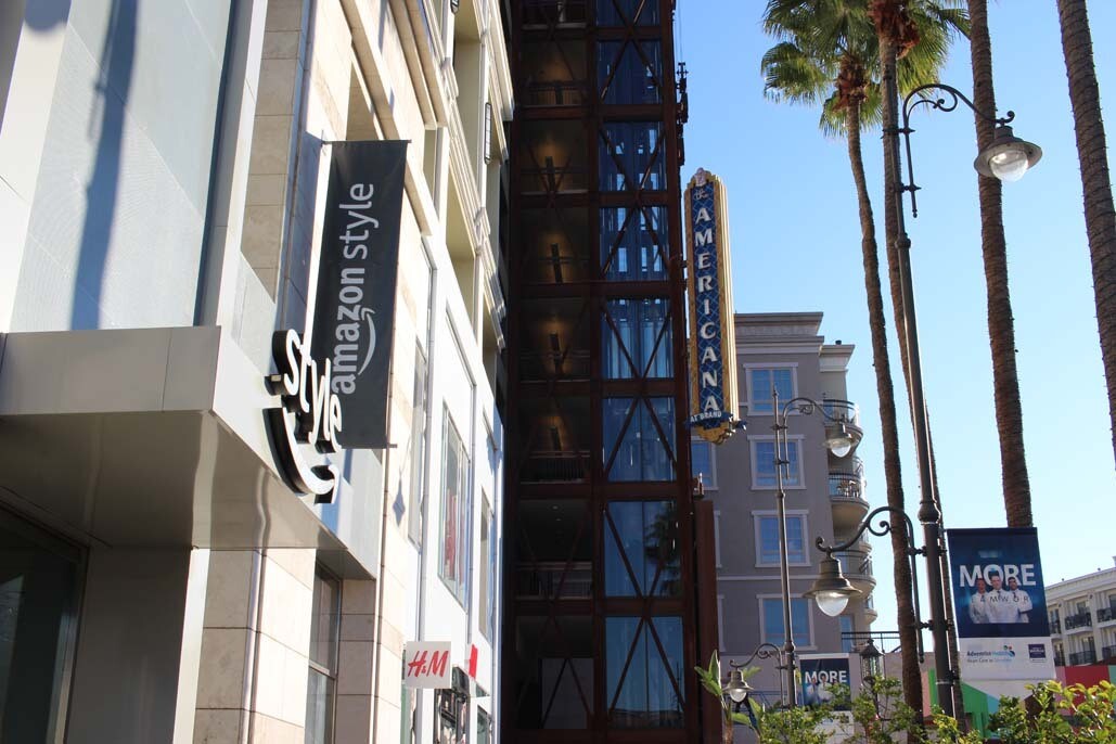 An image of the outside of the Amazon Style store. There is a structure in the background that says "Americana."
