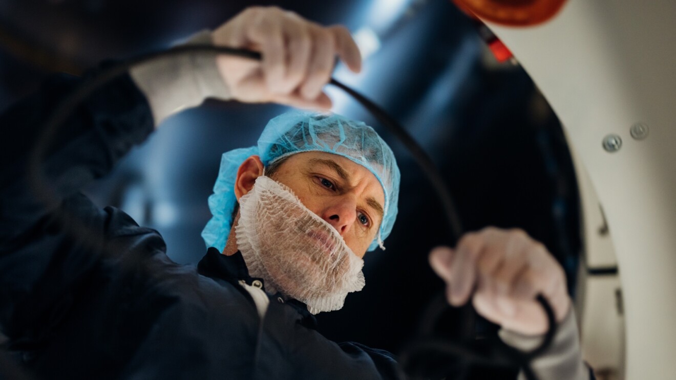 Employee wearing hairnet and mask working inside a Kuiper facility in Florida