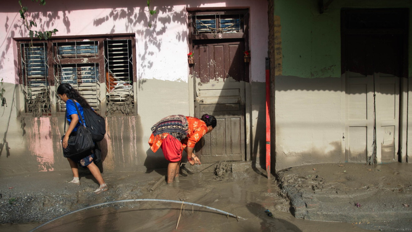 People cleaning up flooded streets