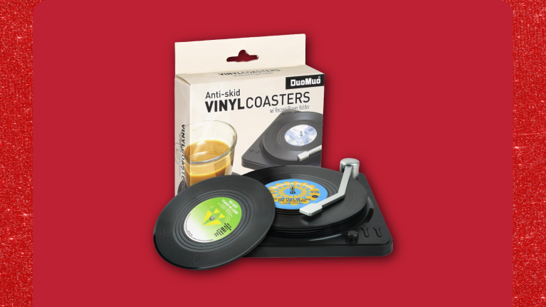 Vinyl record coasters with miniature turntable display stand against red background