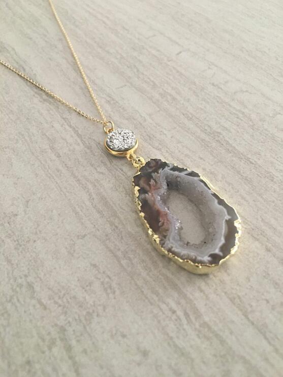 A flat shot of handmade jewelry with raw and semi-precious stones made by T. Victoria.