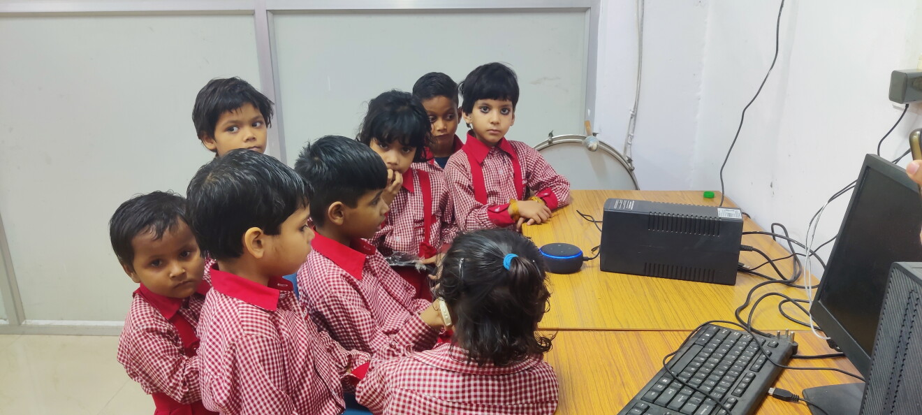 Children at a Bachpan daycare centre interact with Alexa on an Echo Dot smart speaker in their classroom 