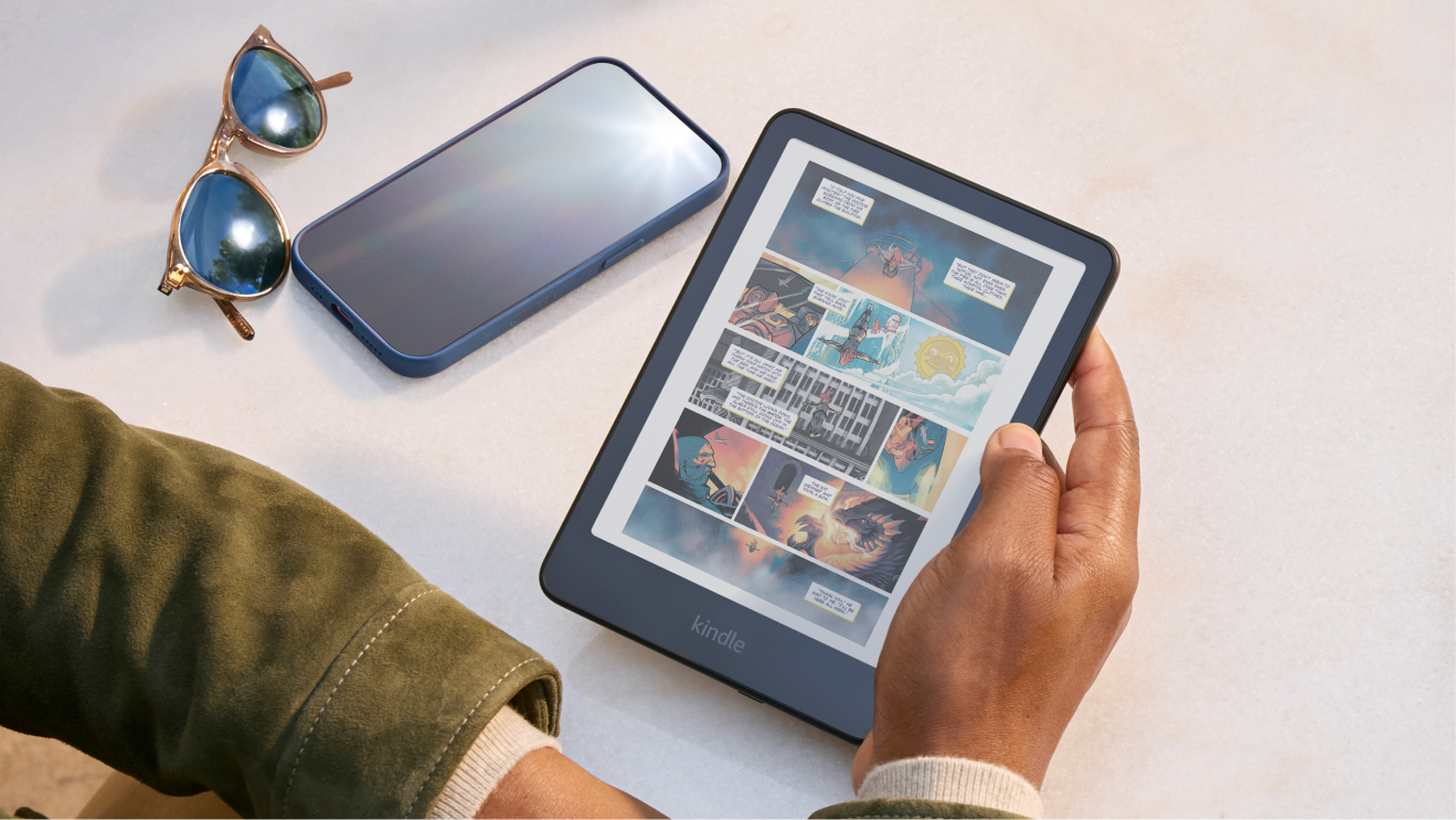 A man reading a colour comic book on a Kindle Colorsoft