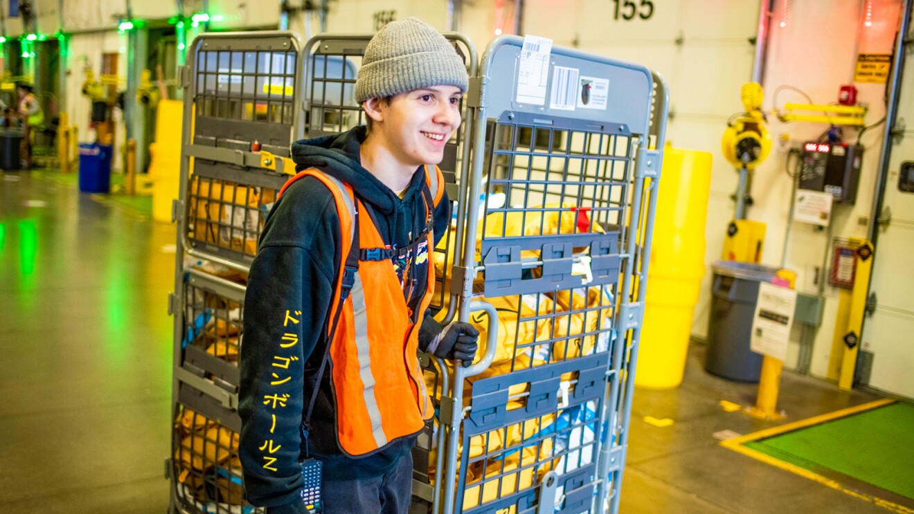 An Amazon operation employee works in a fulfillment center.