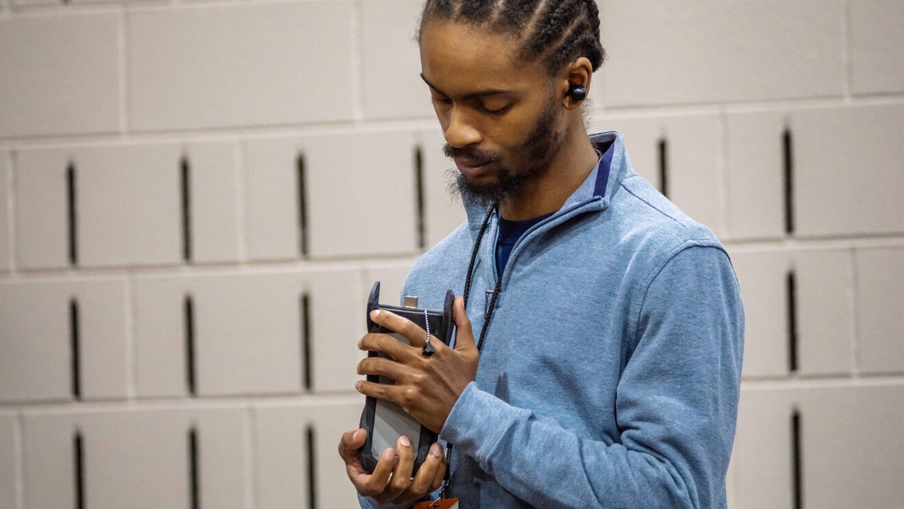 A photo of Aeon Marrow, a systems installer in Columbus, Ohio, holding a fiber-optic fusion splicer.