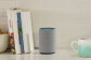 Echo device in a kitchen. To the left are cookbooks, to the right is a stoneware mug that fades from aqua to white. 