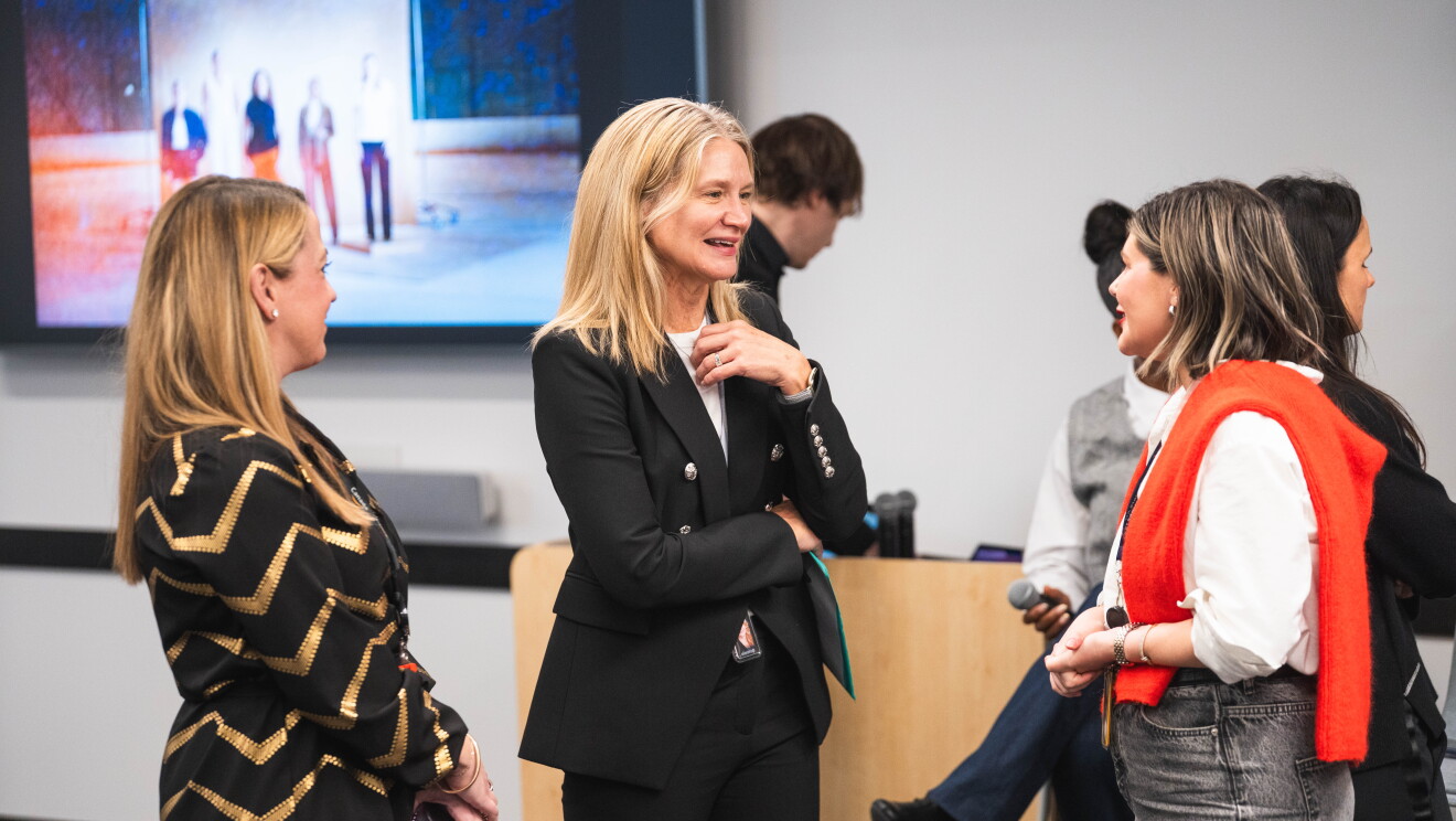women speaking at event 