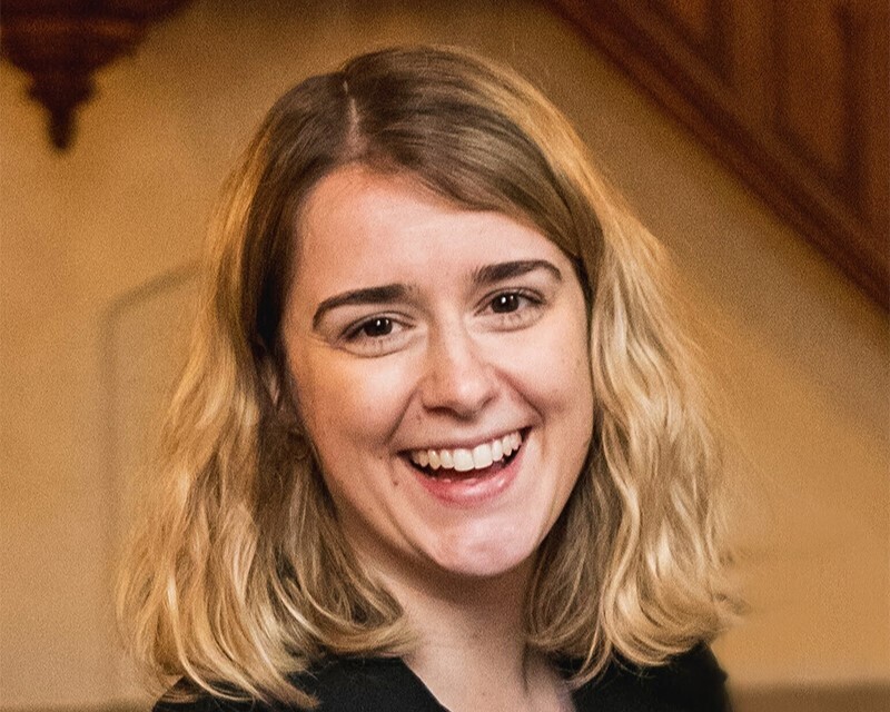 A blonde smiling with a blurred background