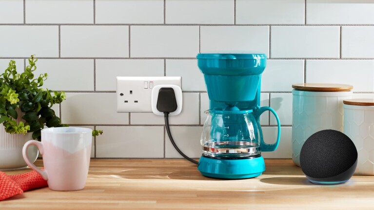 Modern kitchen counter with teal coffee maker and Echo Dot smart speaker