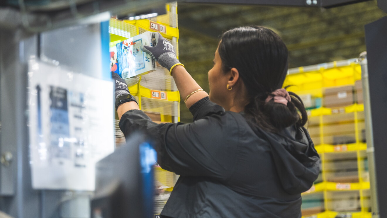 An Amazon employee loading products to a shelf