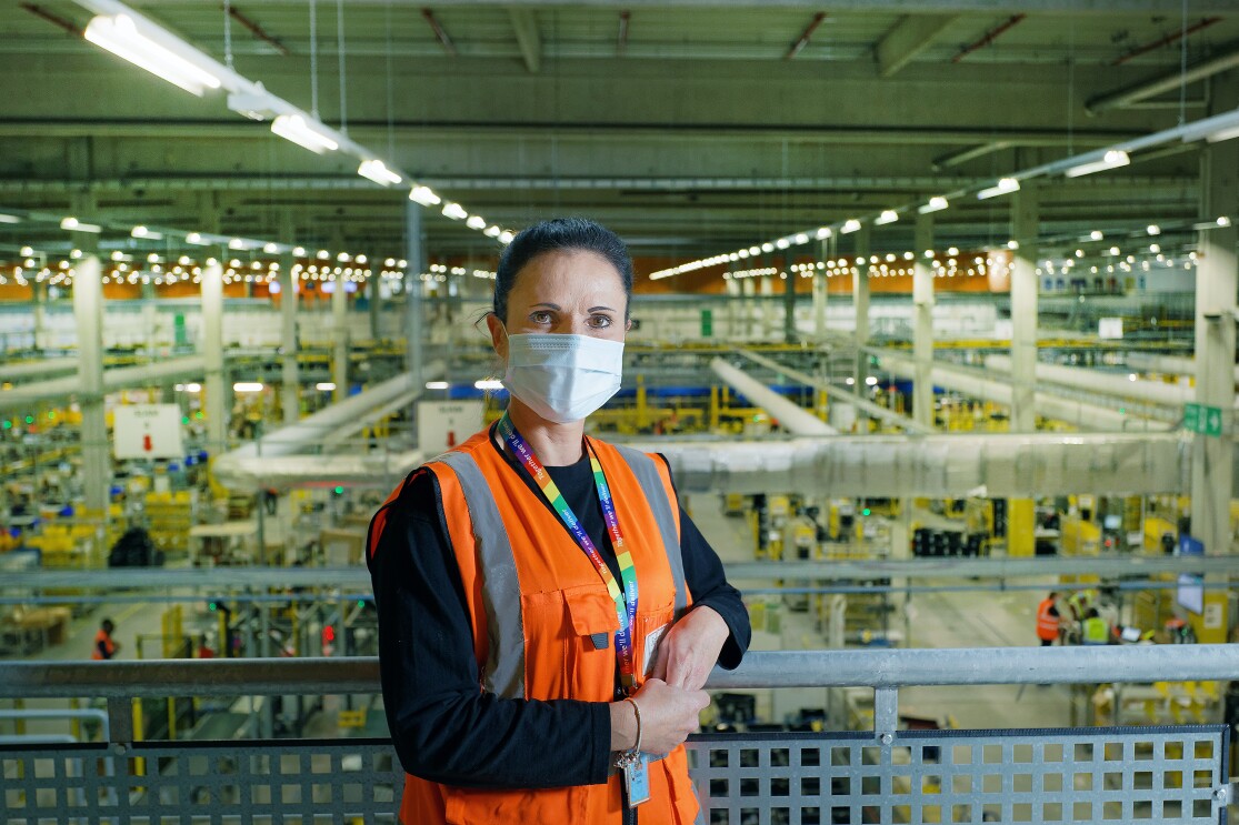Sarah Jones, WHS Coordinator at Amazon's fulfilment centre in Swansea, stood on a mezzanine with the shop-floor in the background