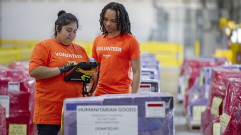 Humanitarian aid distribution center with Amazon volunteer workers
