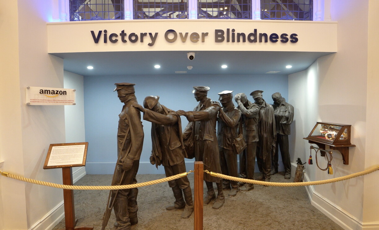 A statue of blind soldiers in the lobby of the centre, with a sign saying 'Victory over Blindness' above.