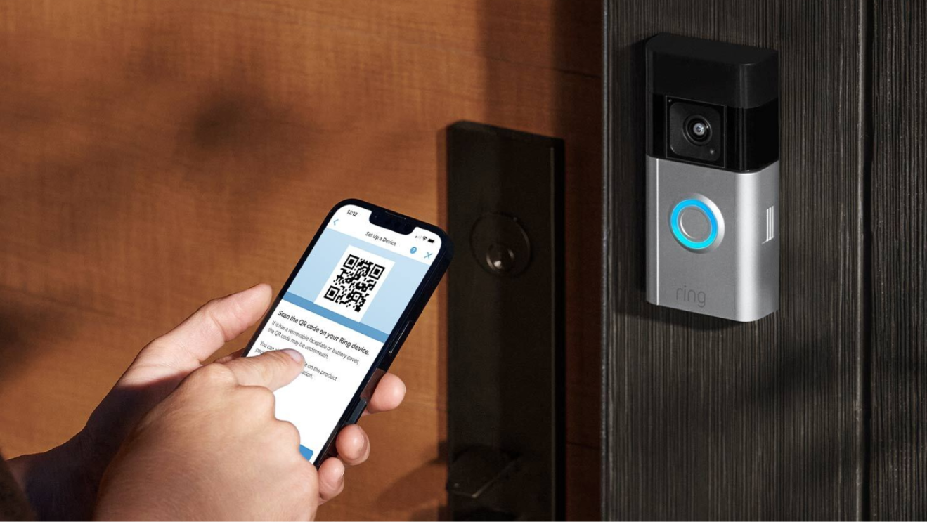 Smartphone scanning QR code next to Ring doorbell