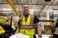 Former army officer and Amazon operations manager Keith Langan holds an Amazon package at the Kemps Creek fulfilment centre
