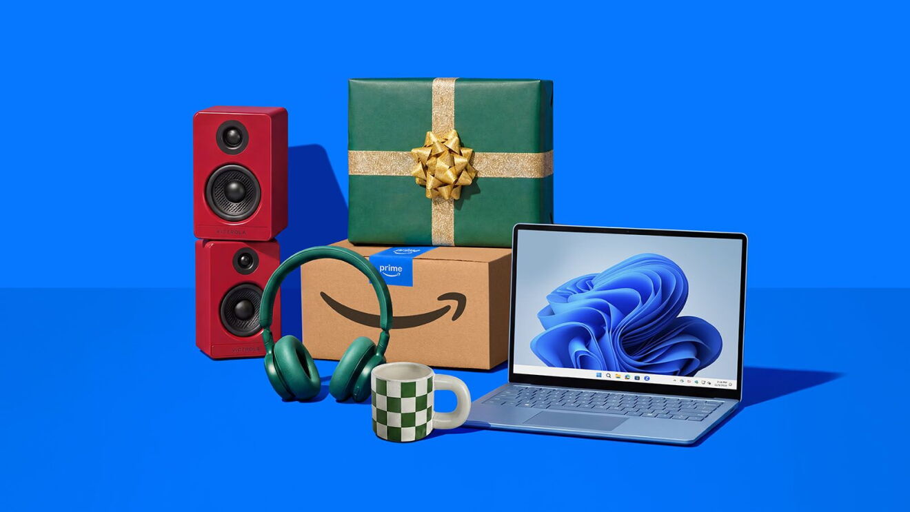 Assorted tech gifts including laptop, wireless headphones, and bookshelf speakers with wrapped presents