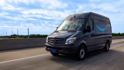 A cargo van decorated with the Amazon smile logo and the word "Prime."