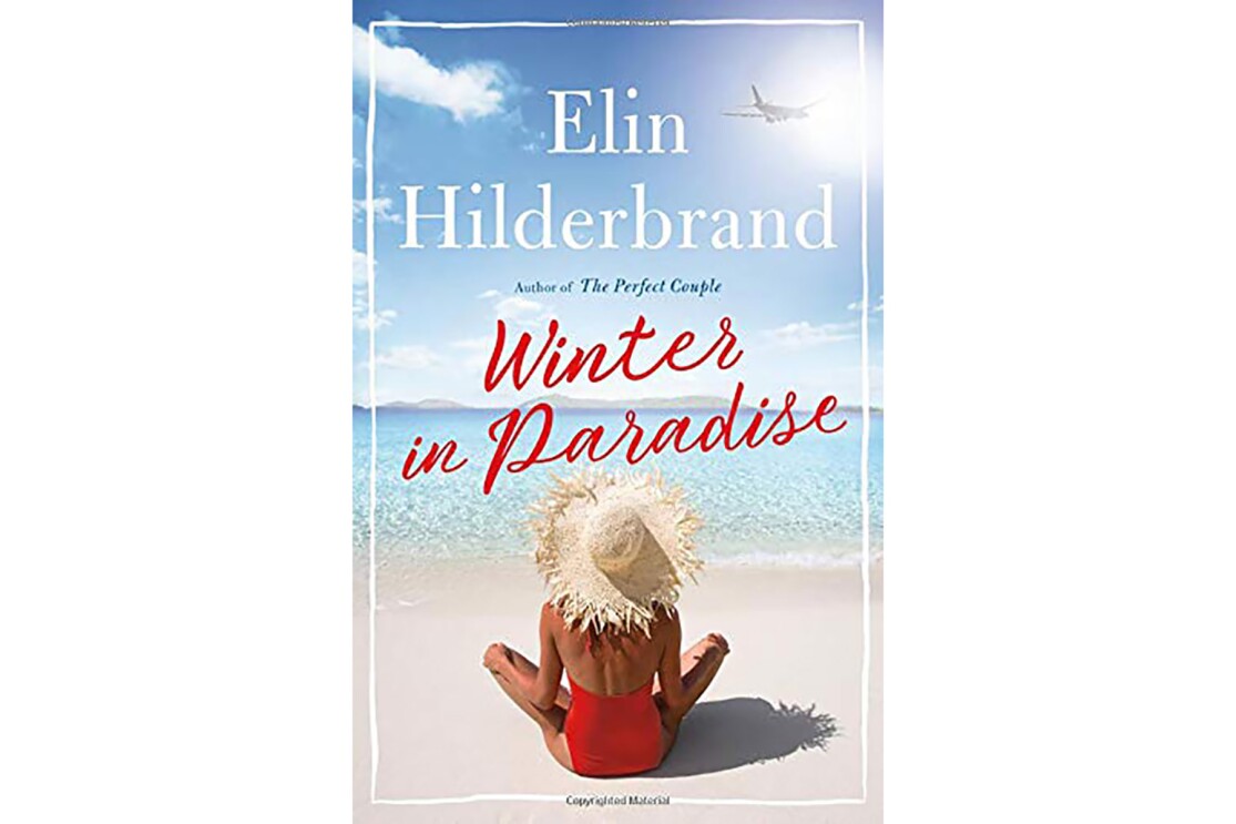 Book cover for "Winter in Paradise" by Elin Hilderbrand snows a tanned woman in a red halter one-piece swim suit and straw sitting cross legged on the beach, looking out toward the ocean.