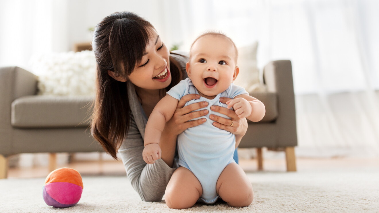 Prime Day 2023 live blog best deals: a happy mother holding her smiling baby.