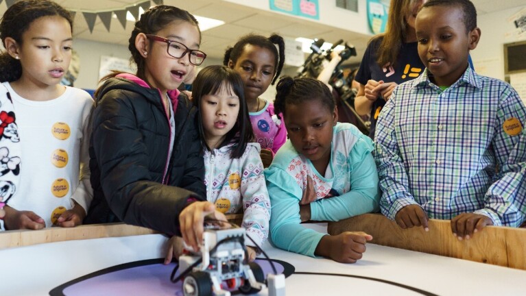 A photo of students operating a robot.