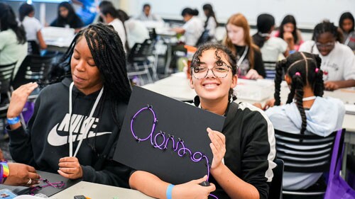 AWS Girls in Tech event with young girls smiling