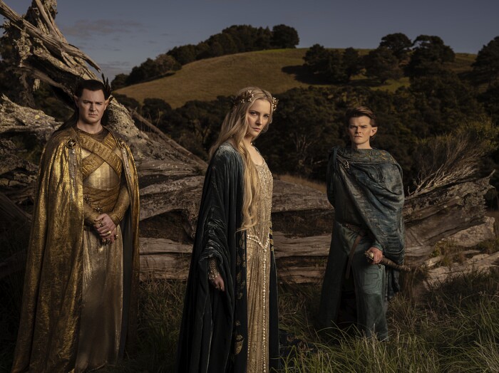 Three Elven characters stand for a photo on the set for the Lord of the Rings: The Rings of Power. Featured in the photo are Galadriel, Elrond, and High King Gil-galad.