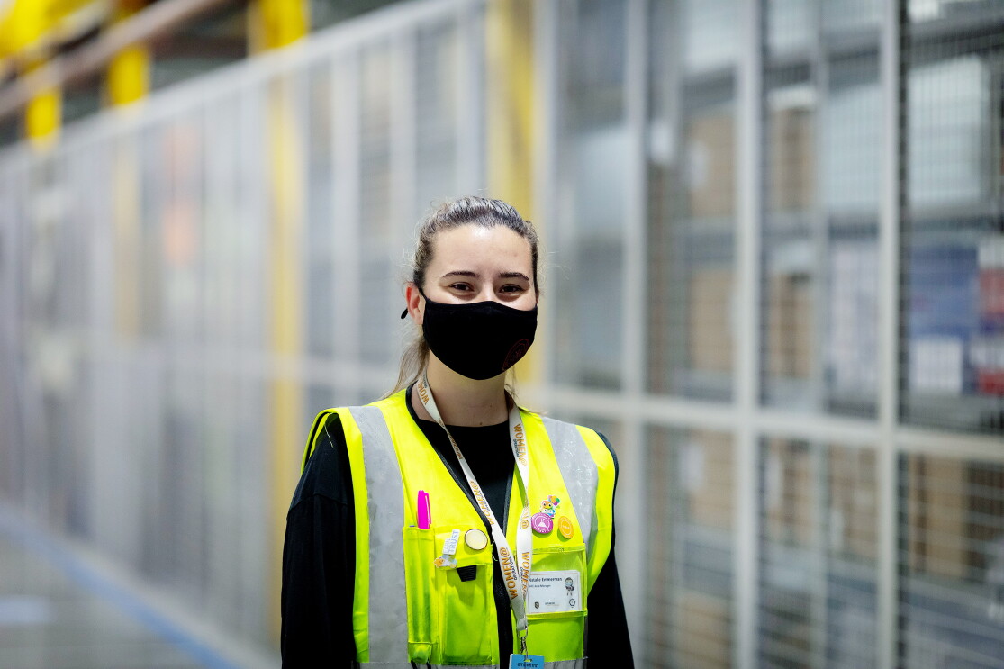 Natalie Emmerman, Area Manager at Amazon's fulfilment centre in Tilbury, pictured wearing a high visibility vest and a face mask.