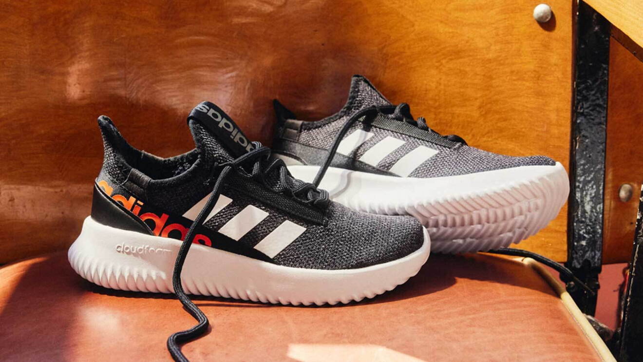 Prime day 2023 live blog best deals: closeup shot of black adidas running shoes sitting on a chair