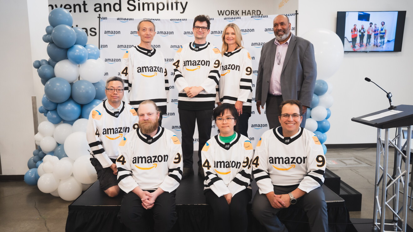 Image of eight employees wearing Amazon hockey jerseys