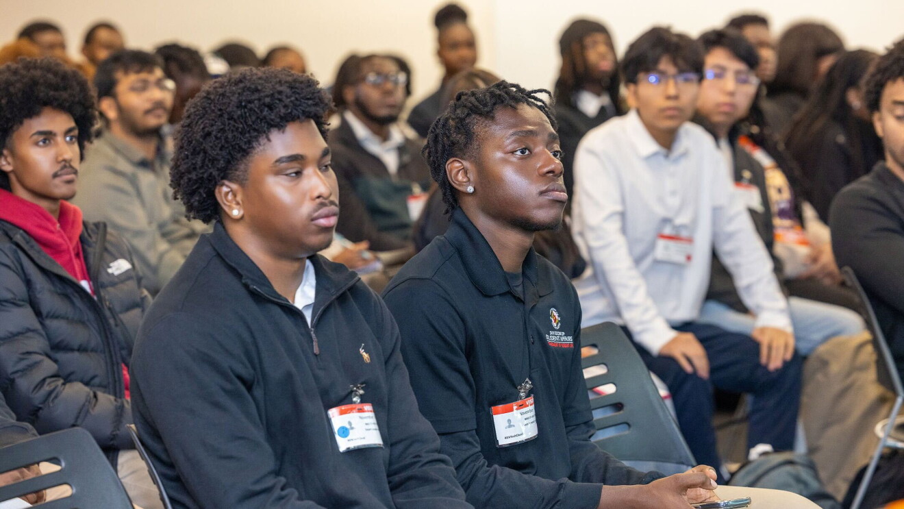 Diverse group of students wearing name tags at educational event