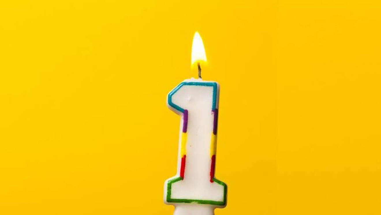 A yellowish-gold background with a lit number 1 candle.