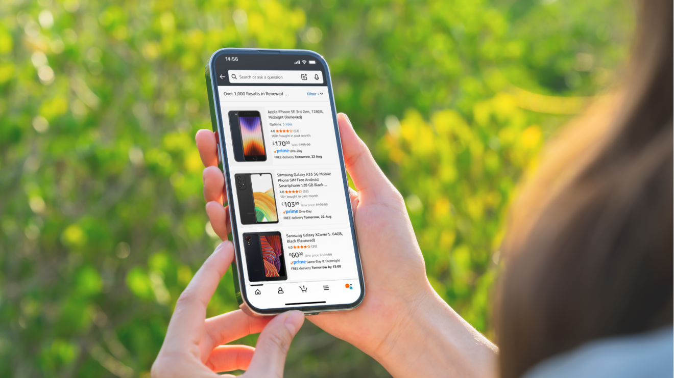 Hands holding smartphone displaying online marketplace for mobile devices