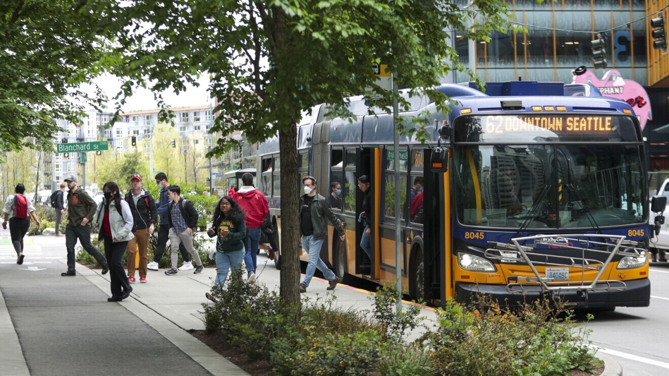 Amazon workers getting off bus in downtown Seattle