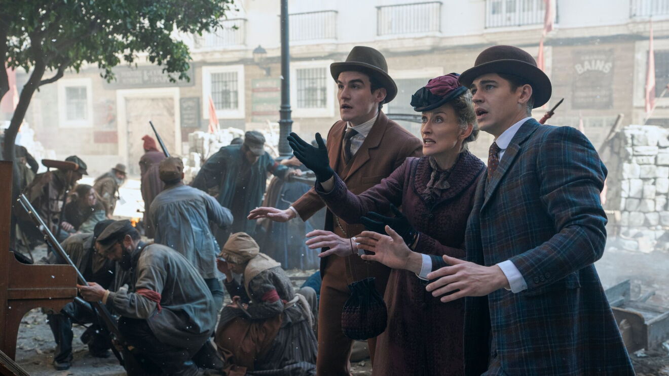 A scene from Young Sherlock on Prime Video with 3 well-dressed Edwardian era people reacting to chaotic street scene