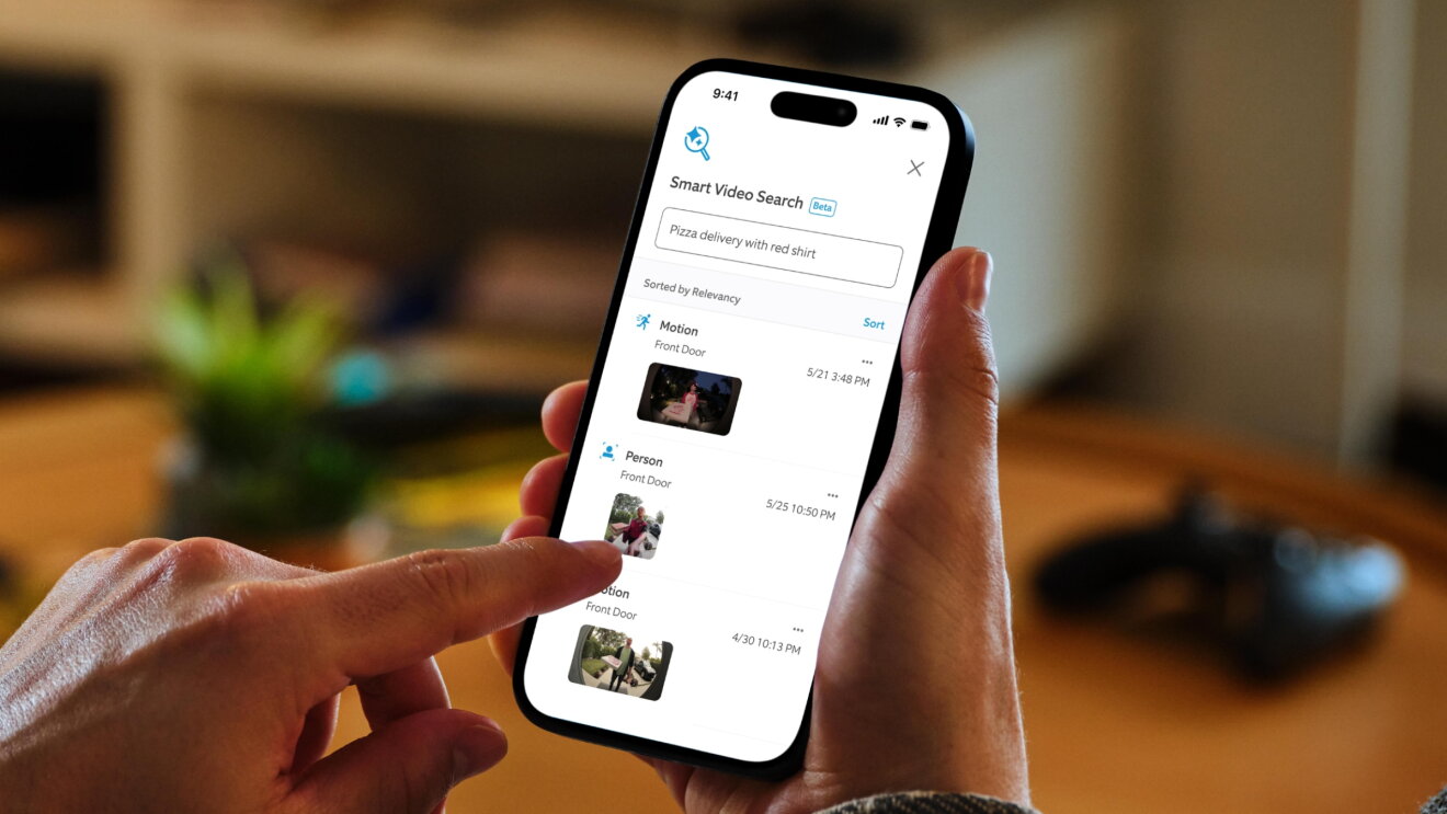 A finger touching the screen of a mobile devices that is displaying thumbnails of video clips from a ring camera.