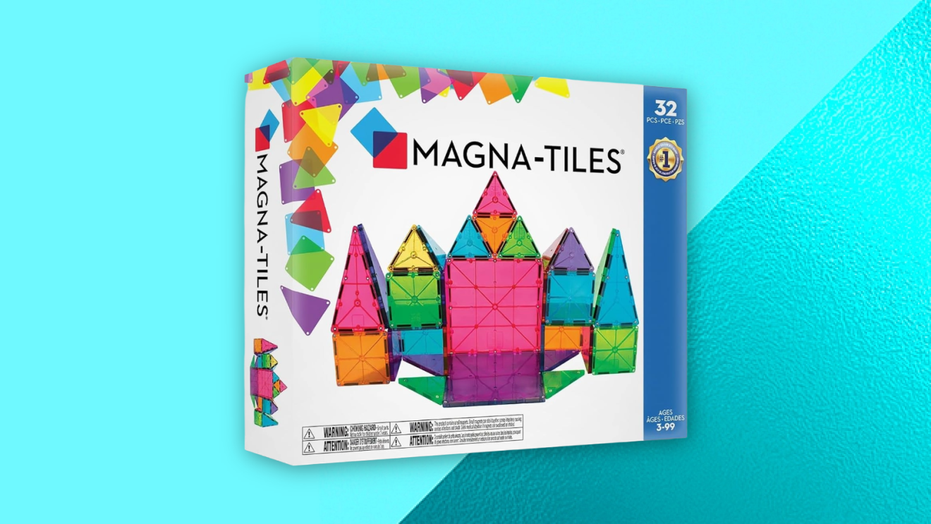 Magna-Tiles 32-piece magnetic building set box showing colorful transparent geometric shapes forming a castle structure