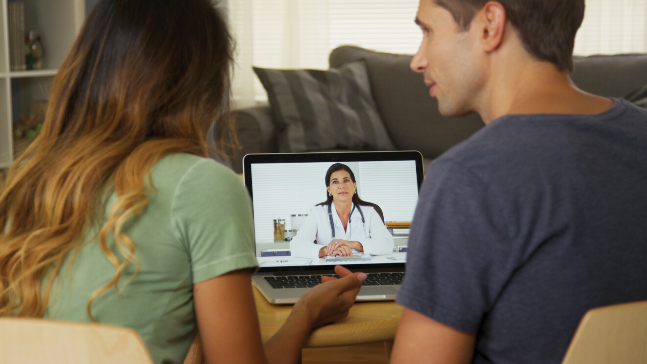 Image of a couple taking a telemedicine appointment on their laptop.