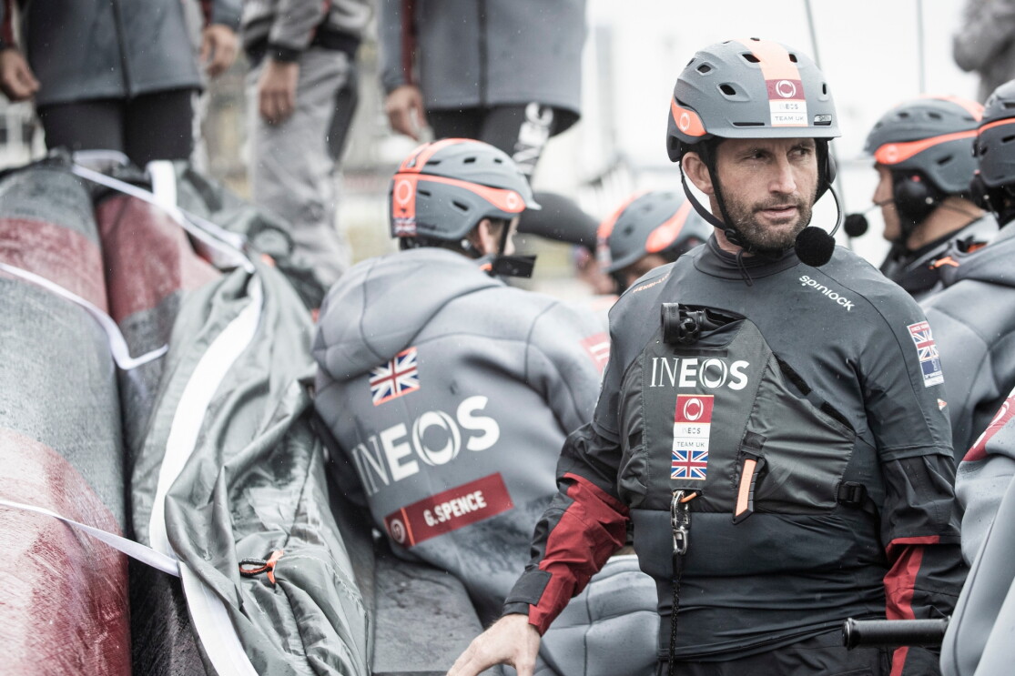 The INEOS Team UK team in their branded sailing gear.  Sir Ben Ainslie, who leads the team is a the front of the picture. 