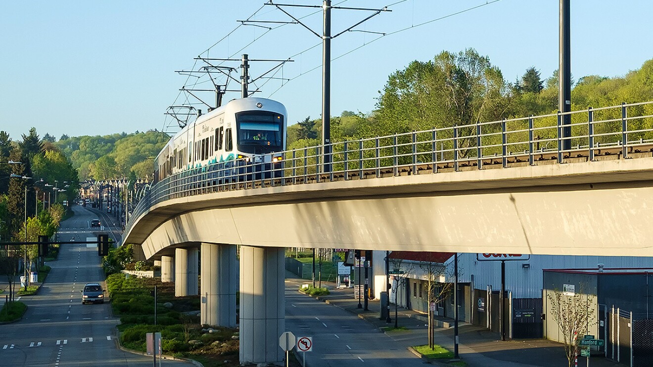An image of a lightrail driving through a city.