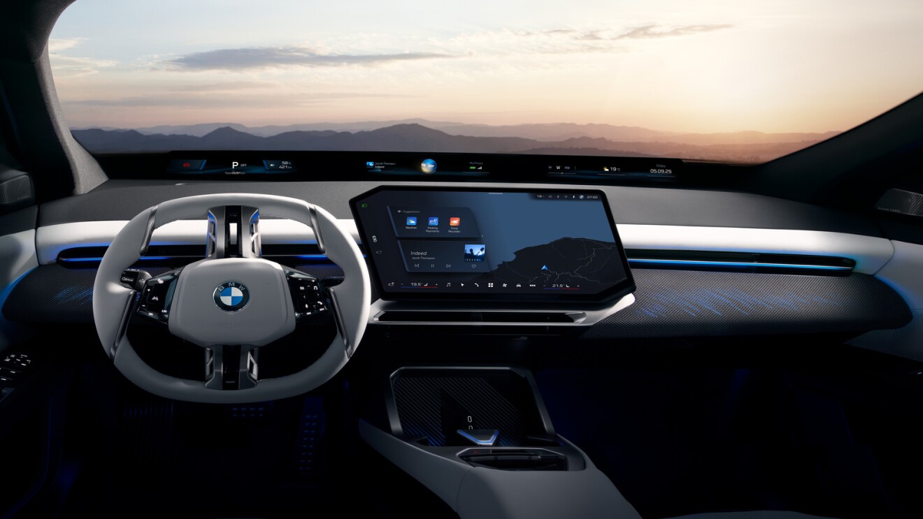 Futuristic BMW interior with large touchscreen and panoramic windshield view