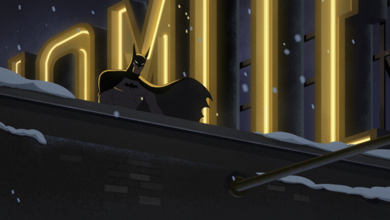 Batman stands on a rooftop looking out to the distance at night